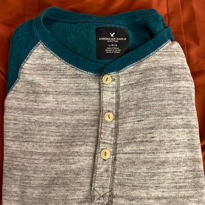 Large teal baseball style long sleeved tee shirt. Worm maybe two times